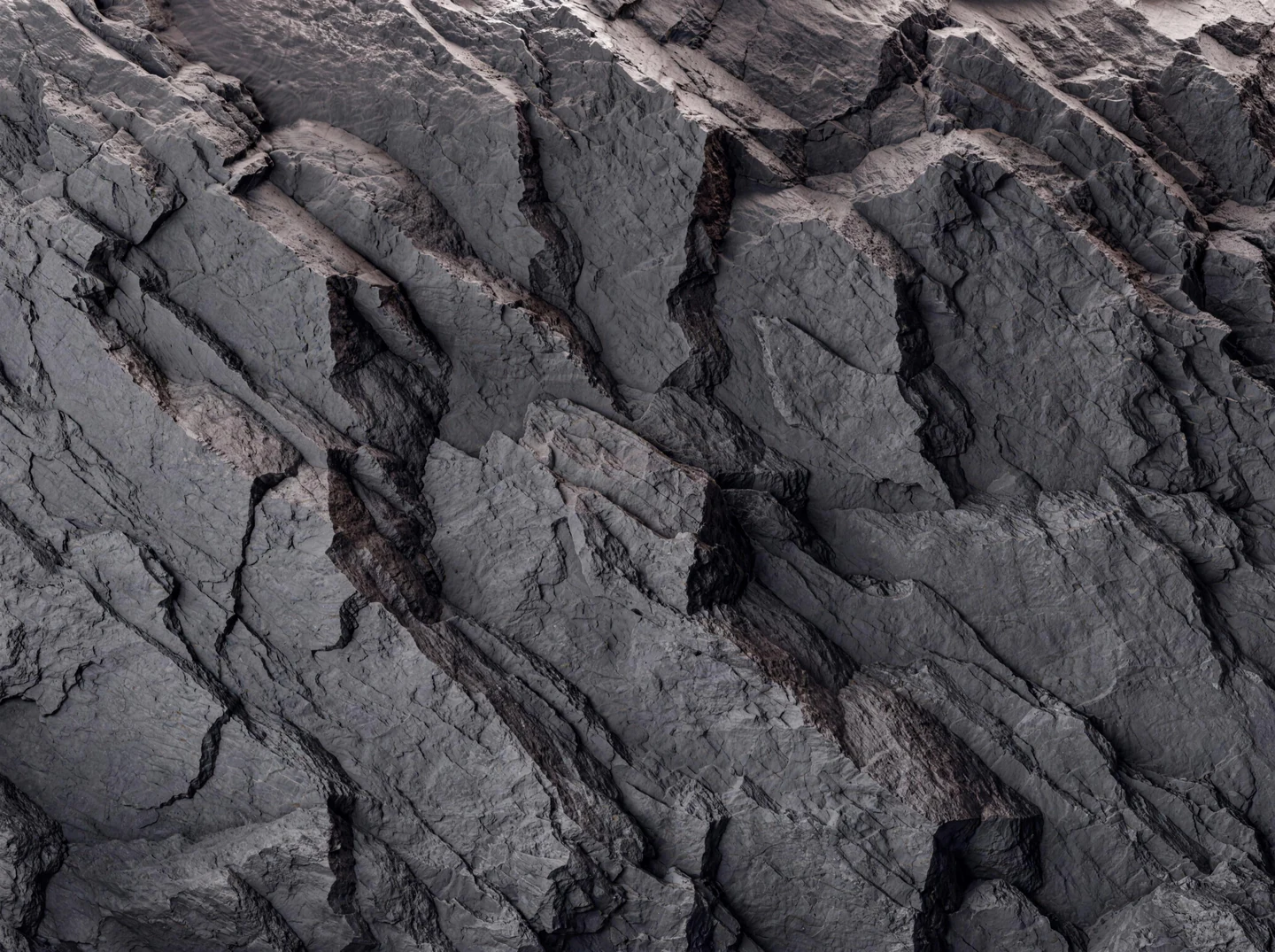 Close-up of dark Basalt rock relief with fractured planes