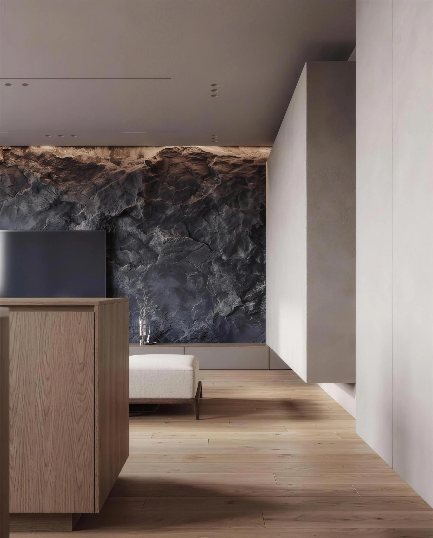 Dark Basalt rock relief wall with warm lighting in a contemporary interior with pale walls and wood furniture